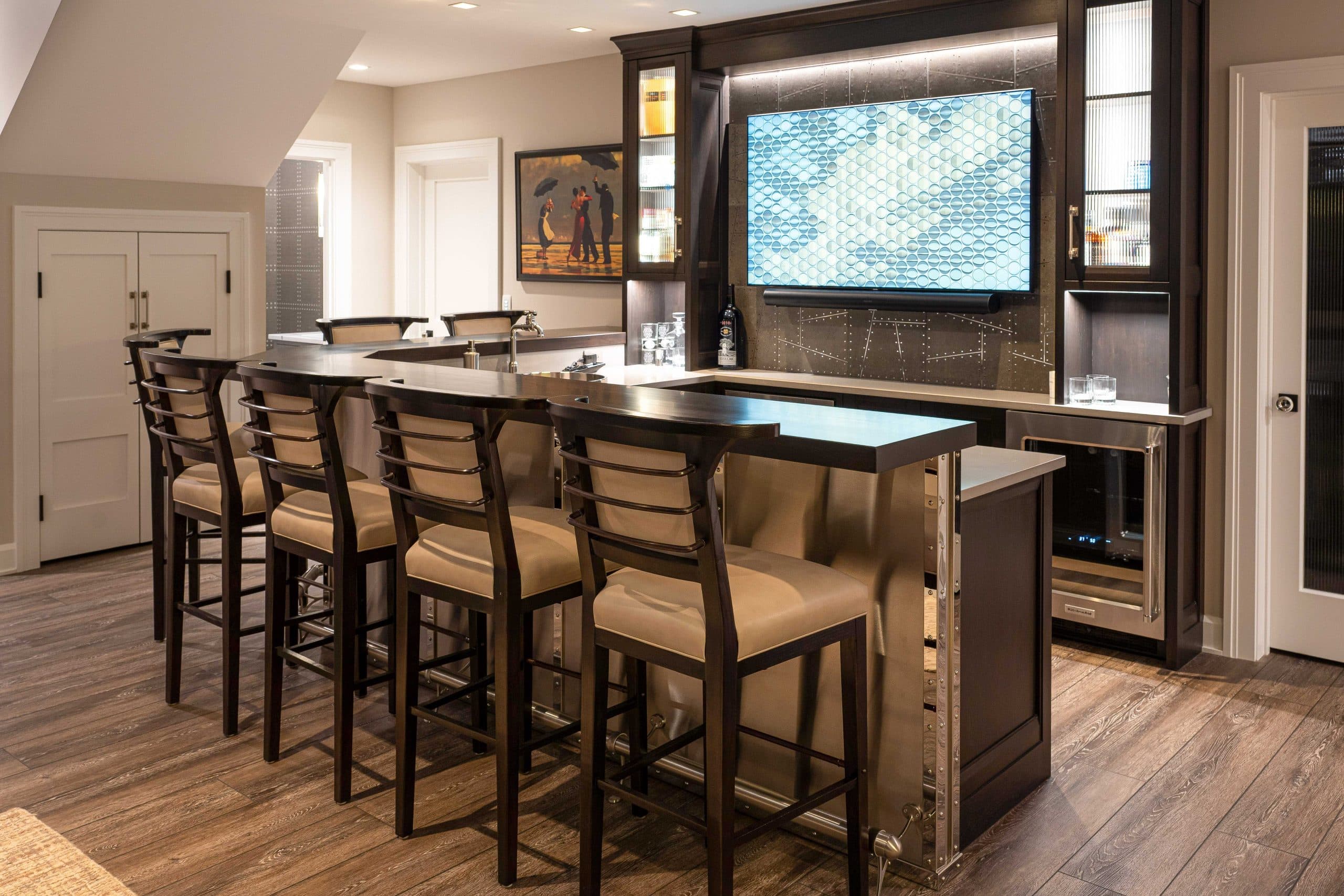 Basement bar with barstools and tv