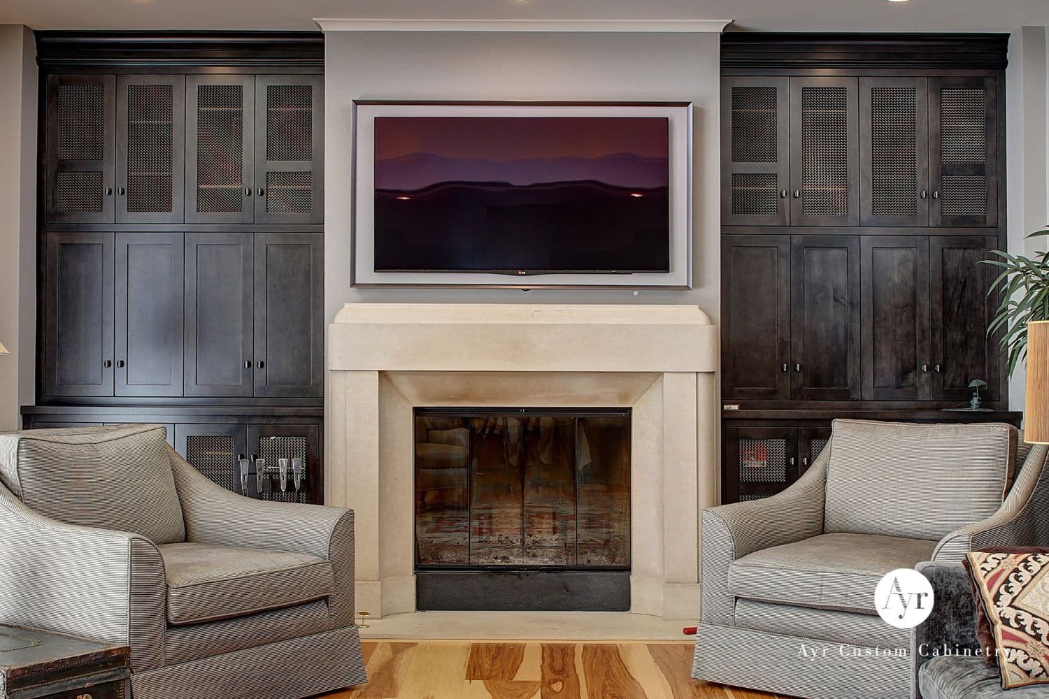 Wall of custom entertainment center with cabinets, shelves, and lattice style design on cabinets