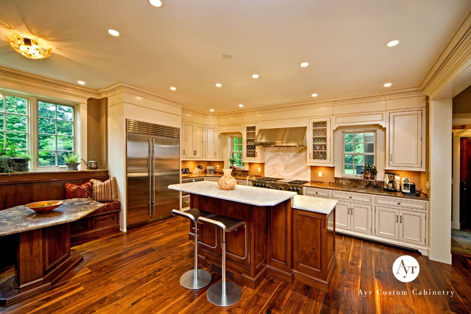 Kitchen & Bar Cabinets in South Bend Indiana with white cabinets, custom wooden island and matching table and bench