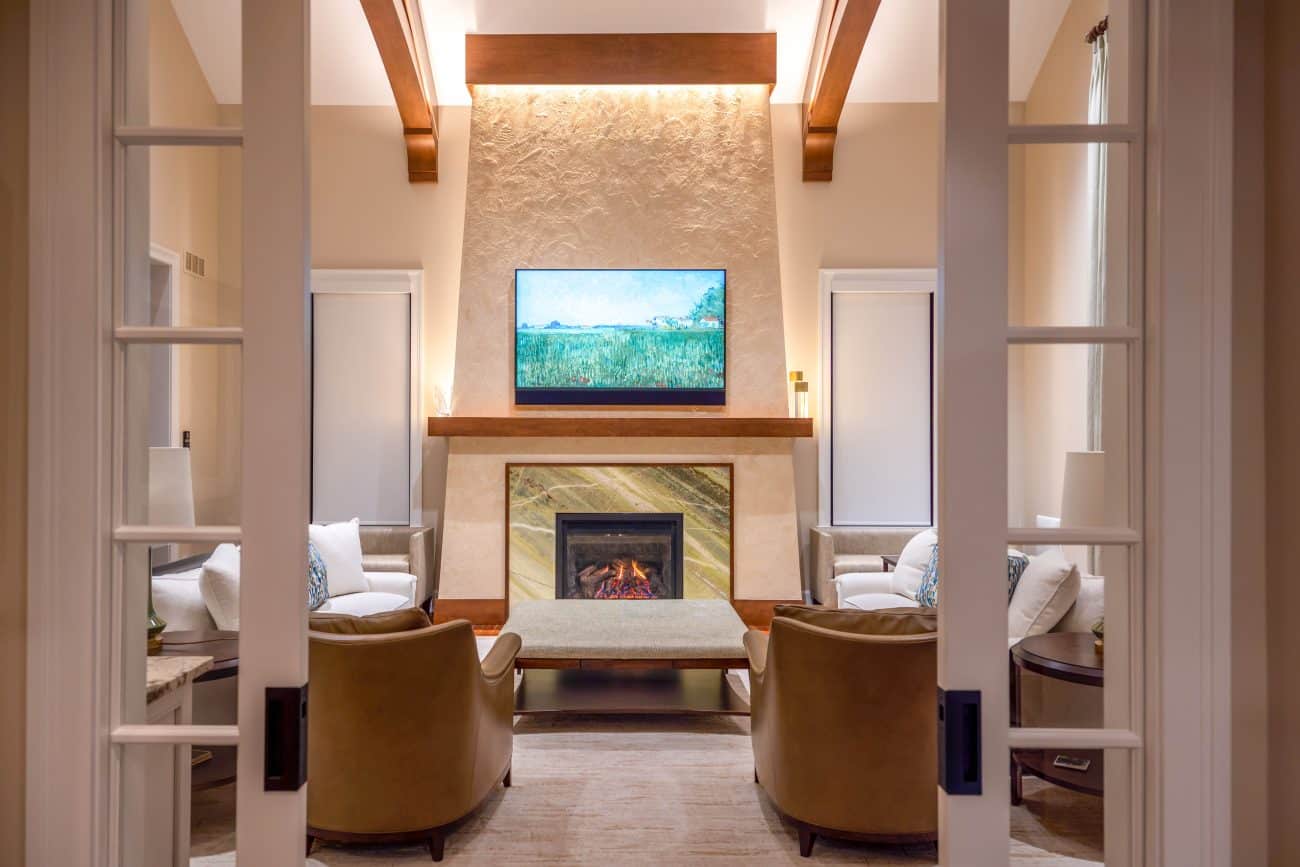 Wooden trusses on a vaulted ceiling in living room with closed doors