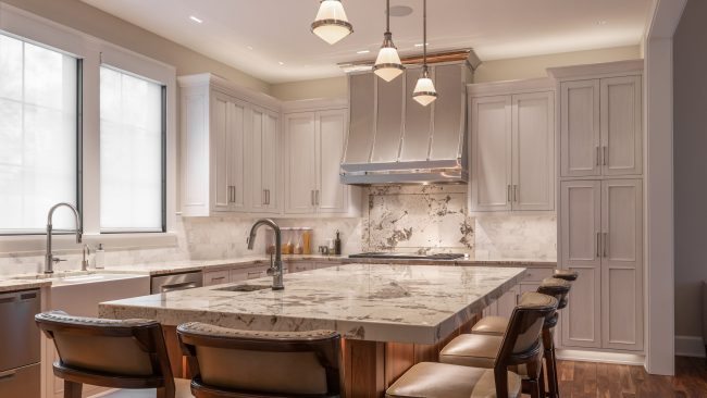 Gray inset kitchen cabinets with marble countertop island